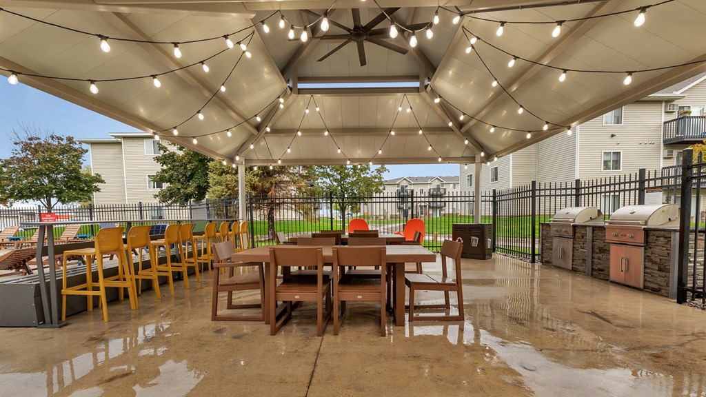 a patio with a table and chairs under a canopy