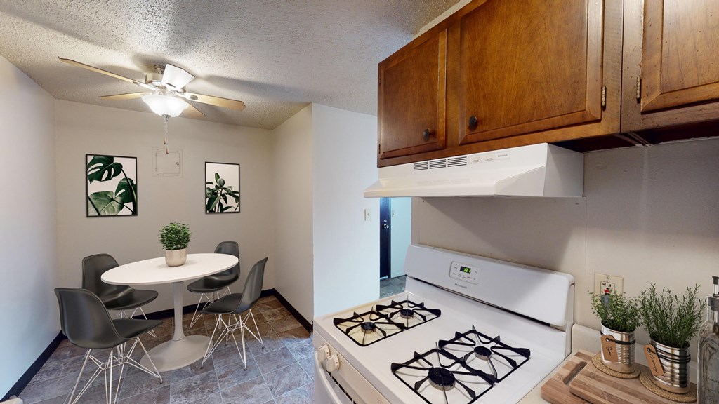 Kitchen with Wood Cabinets and Circular Dining Table