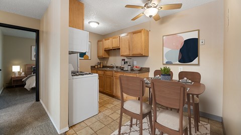 an open kitchen and dining area with a dining table and chairs