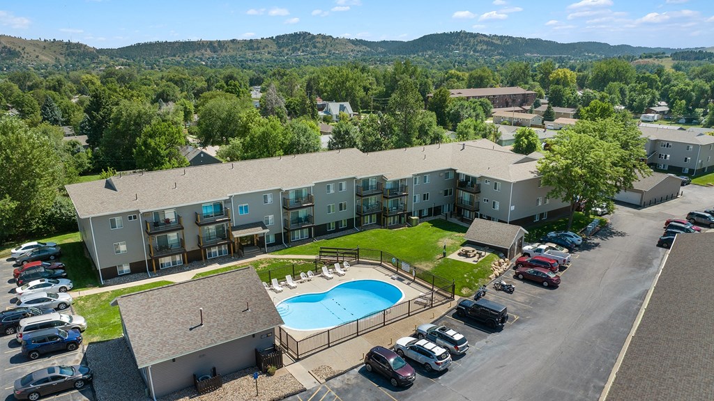 a view of a building from above with a swimming pool