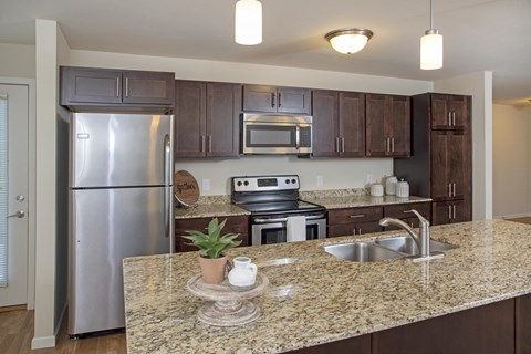 a kitchen with stainless steel appliances and granite counter tops