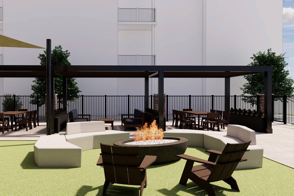 A patio with a fire pit and chairs.