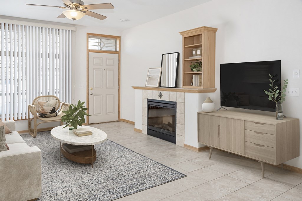 a living room with a fireplace and a tv