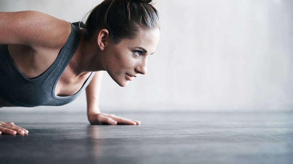a woman is doing a plank on the floor