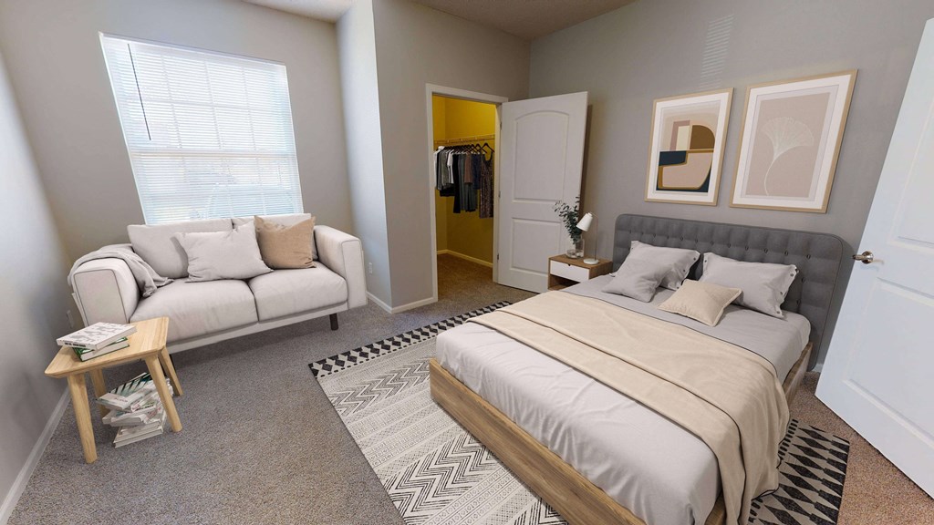 Spacious master bedroom complete with a large window, seating nook, and walk in closet.