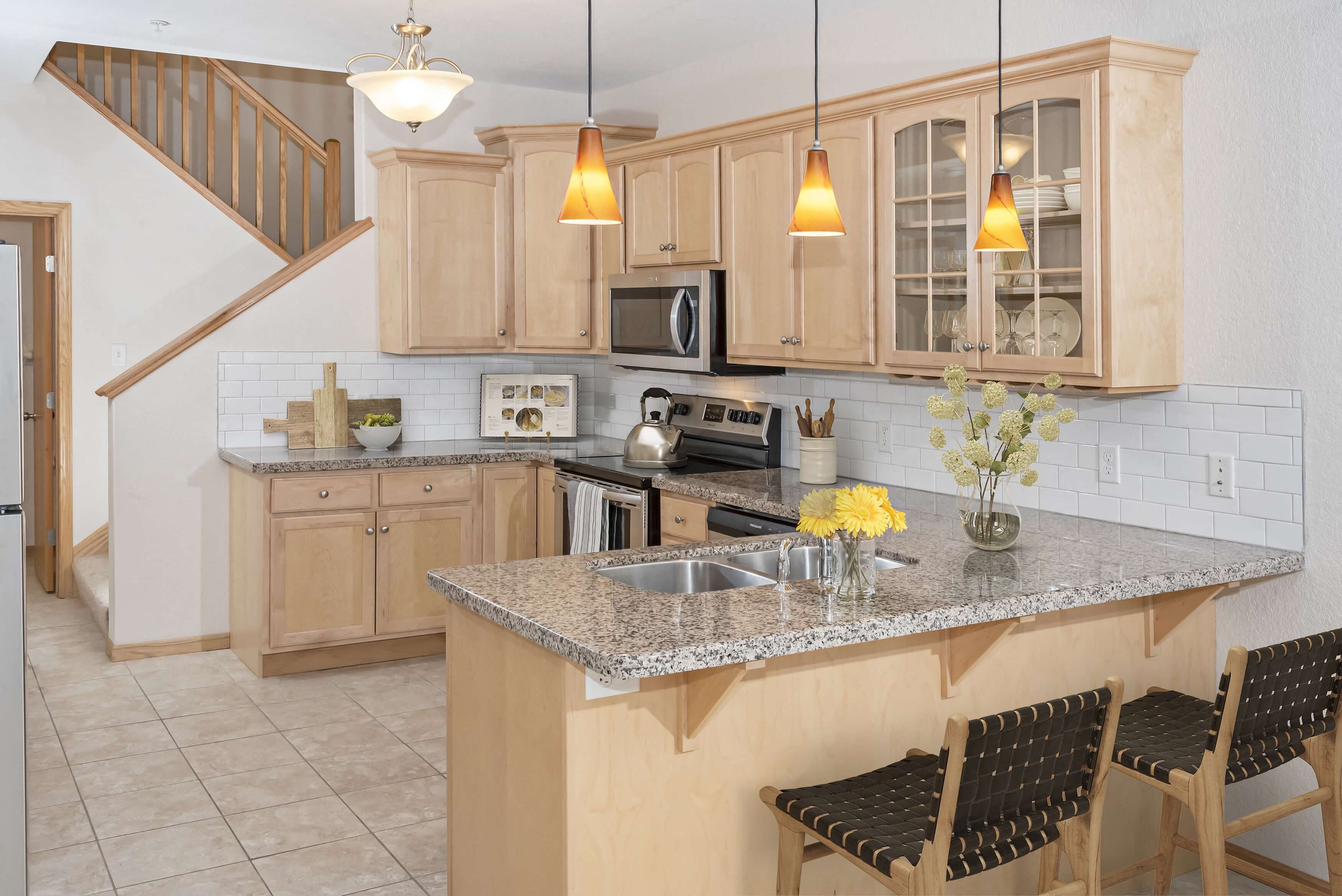 a kitchen with wooden cabinets and a granite countertop