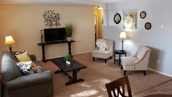 Living room with open layout filled with natural light from the window. - Photo Gallery 5
