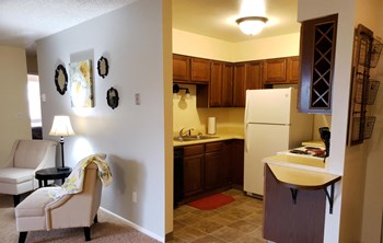 Split view of both the living area and kitchen showcasing the ample cabinet space in the kitchen. - Photo Gallery 4
