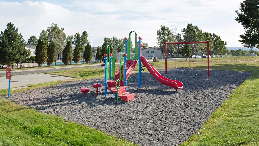 a playground with a slide and other toys in a park