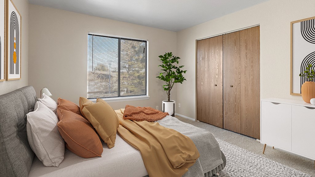 a bedroom with a bed with pillows and blankets on it