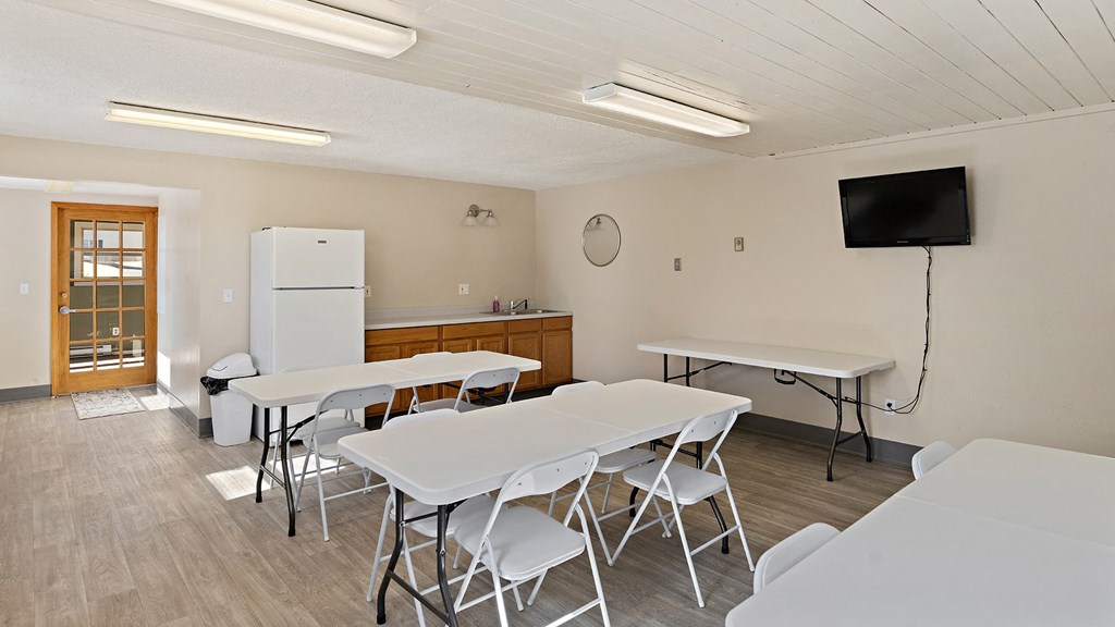 a dining room with tables and chairs and a television