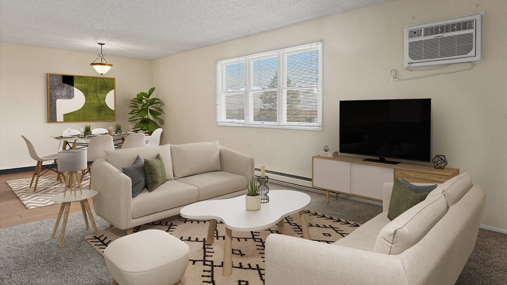 a living room with couches and a table and a television