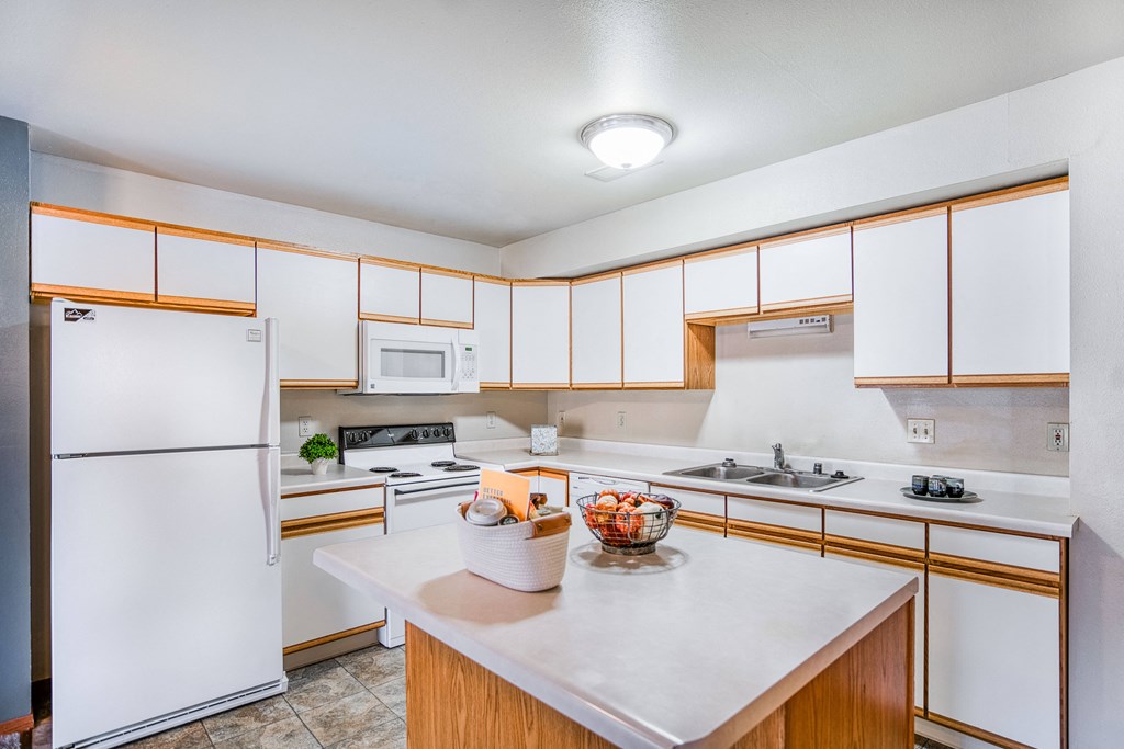 a kitchen with white appliances and wooden cabinets
