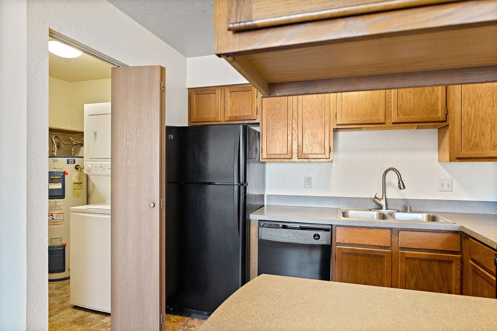 a kitchen with black appliances and wooden cabinets