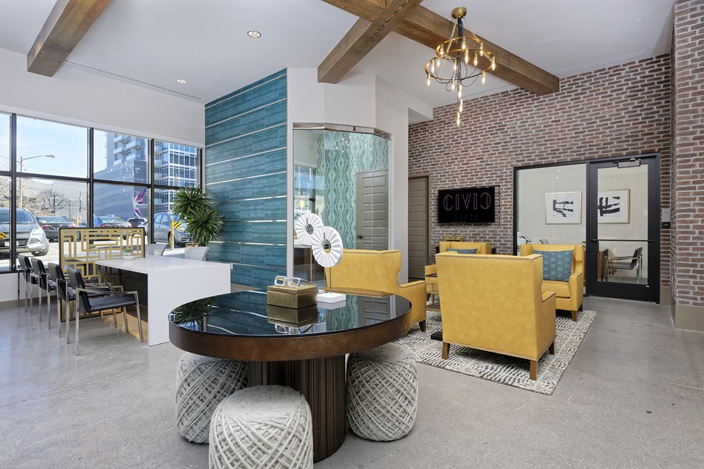 Lobby area with circular table, large sofa chairs and boardroom style table