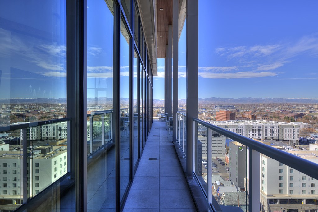 Sky lounge balcony, with concrete pillars and walkway and glass railing
