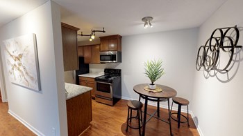 Open kitchen leading separate dining area with overhead lighting. - Photo Gallery 3