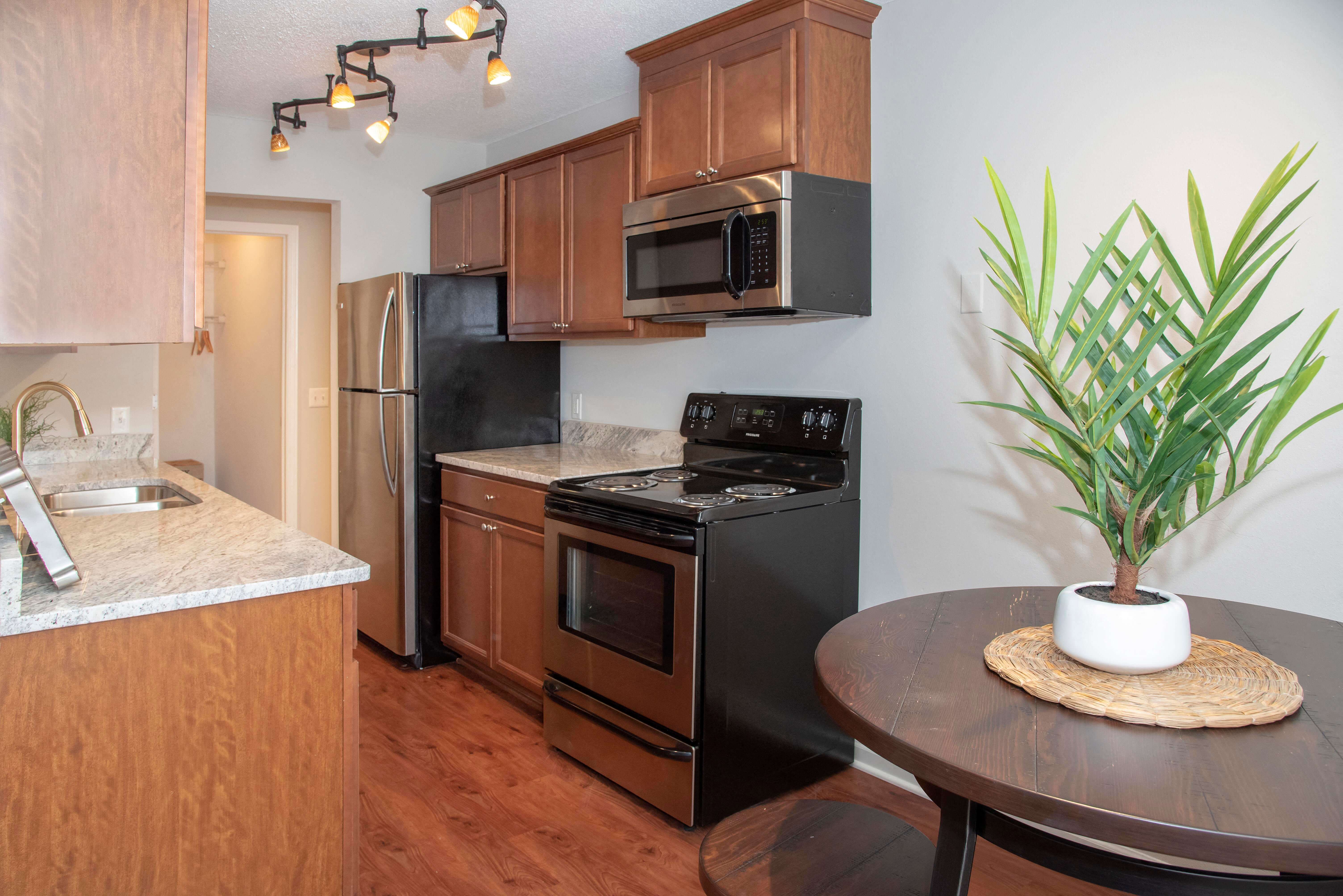 Bright kitchen with classic finishes and updated stainless steel appliances.