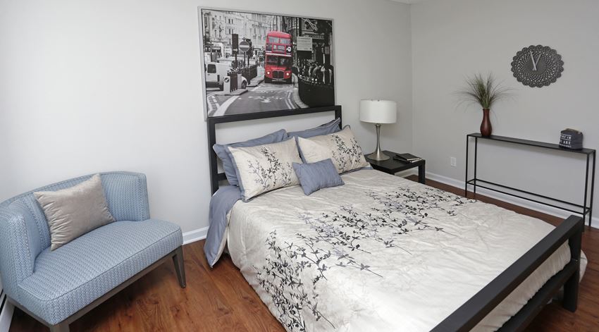a bedroom with a bed and a chair