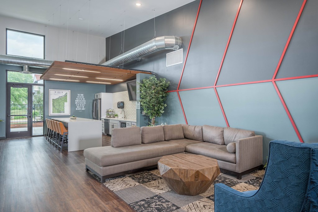 A modern living room with a grey sofa and a wooden coffee table.