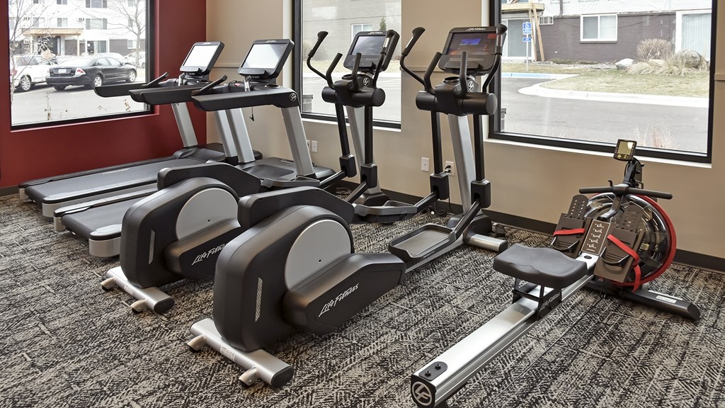 a group of exercise machines in a gym