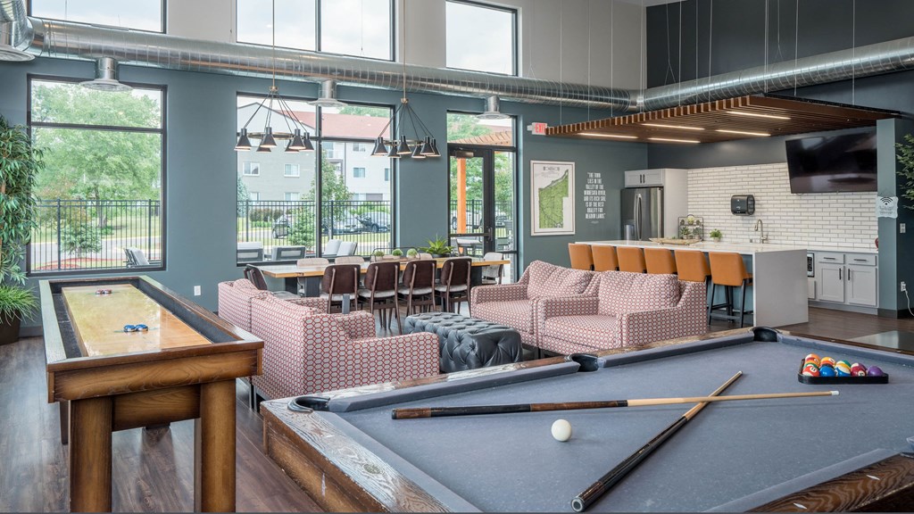 a common room with a pool table and a bar