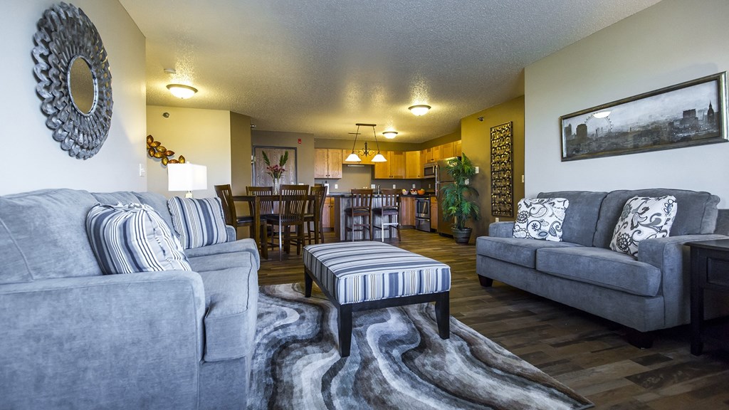 a living room and dining room with couches and a table