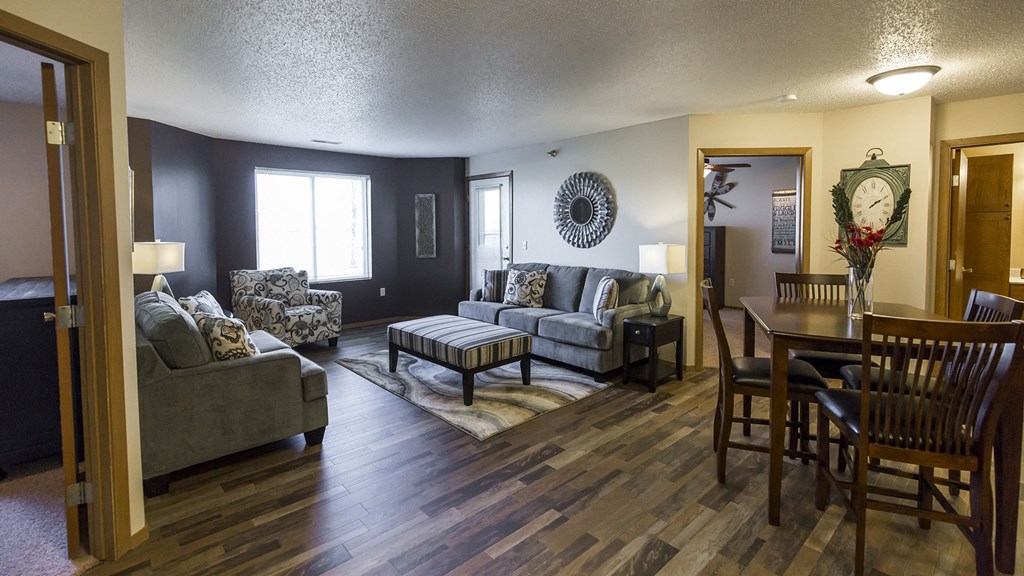 a living room and dining room with furniture and a table