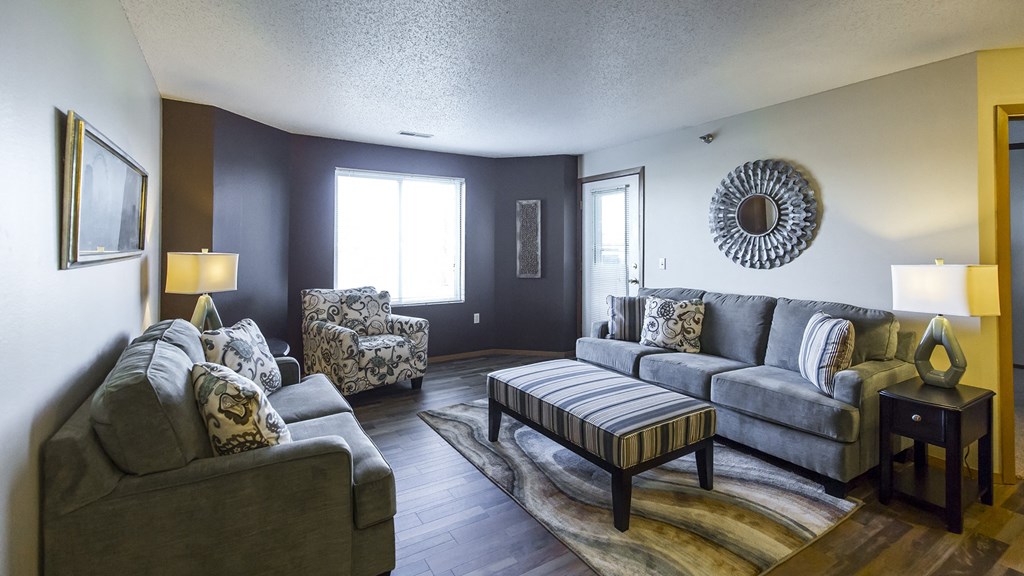 a living room with couches and chairs and a table