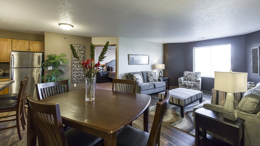 the view of a living room and dining room with a table and chairs