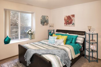 Bright and cozy bedroom with ample natural light coming in from the window across from the bed. - Photo Gallery 5