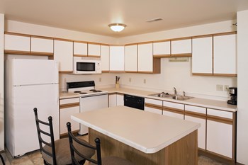 Kitchen with tons of storage space in the white cabinetry. - Photo Gallery 3