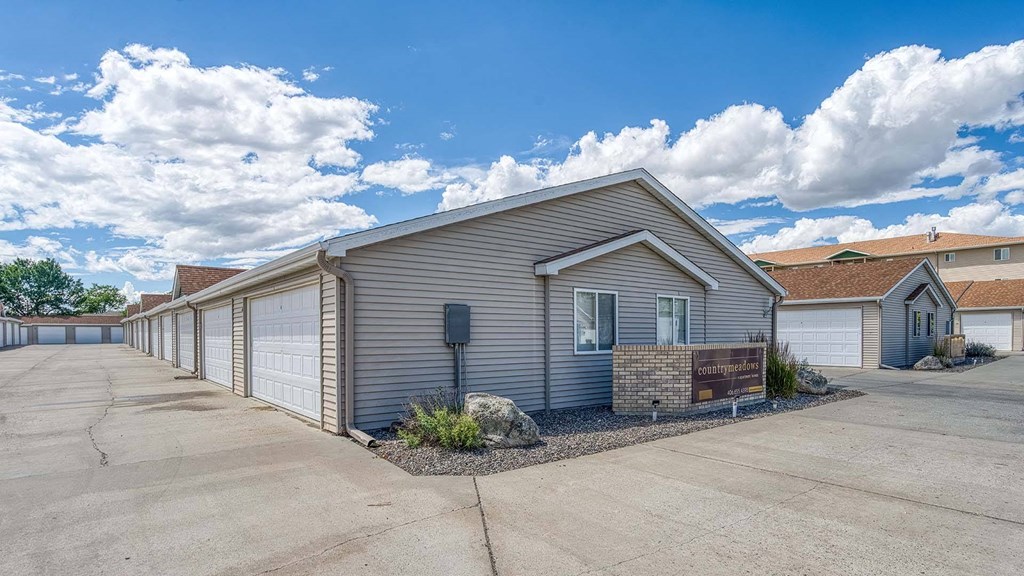an empty parking lot in front of a house