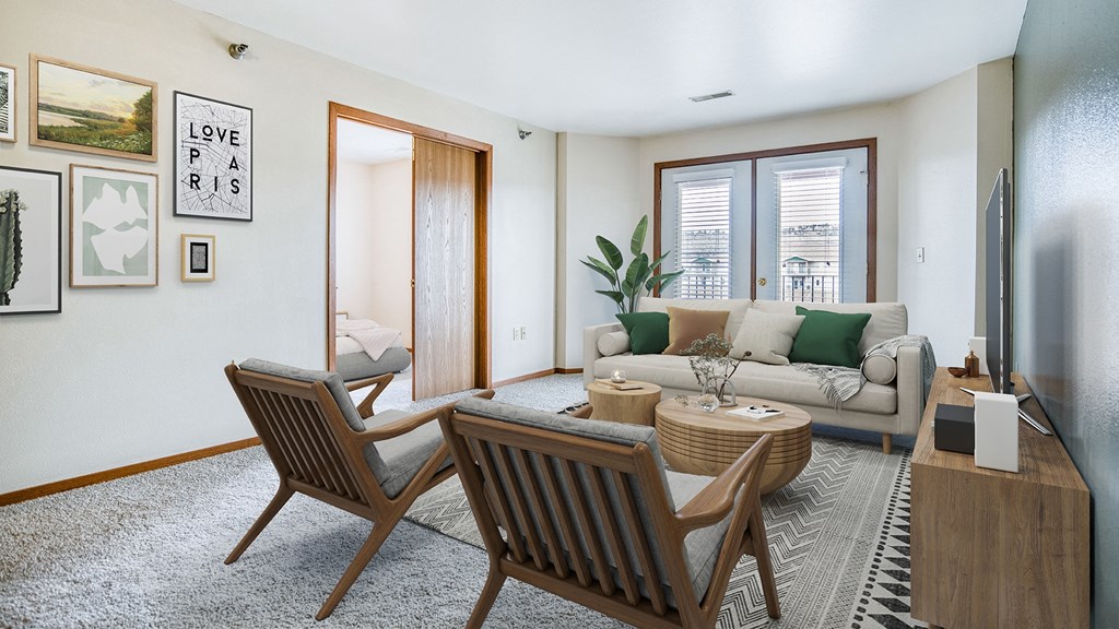 a living room with a couch and a table and two chairs
