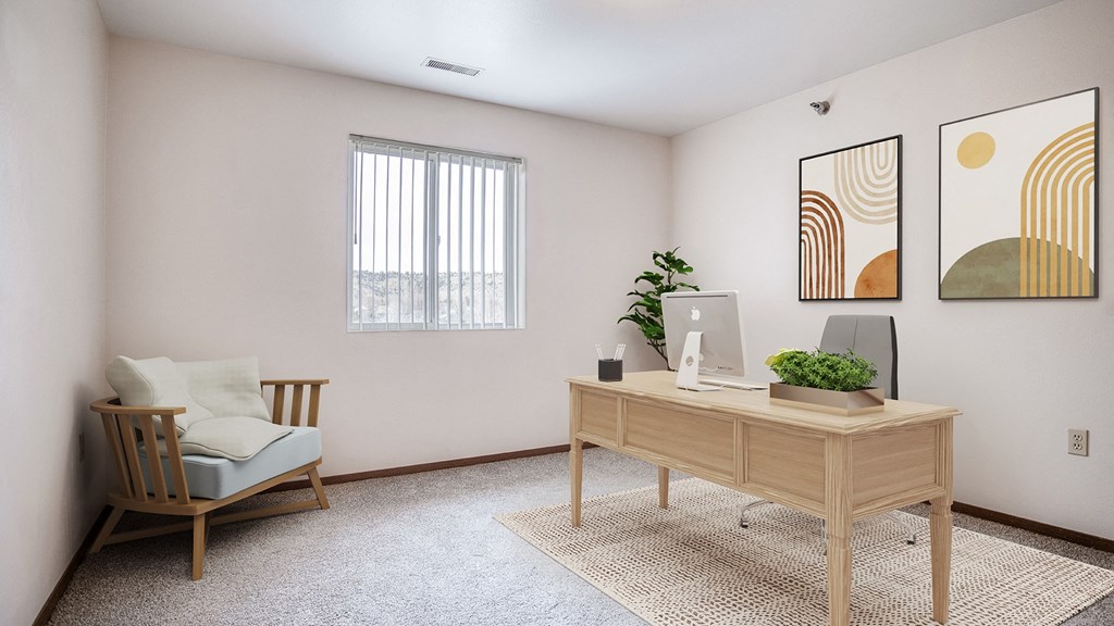 an office with a desk and a chair and a window