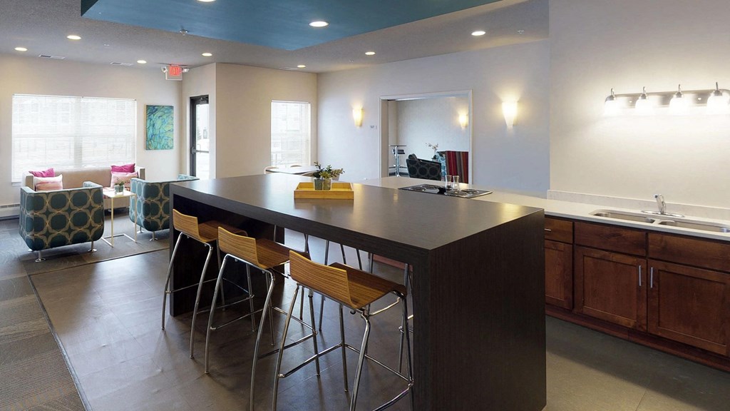 a kitchen with a counter top and bar stools