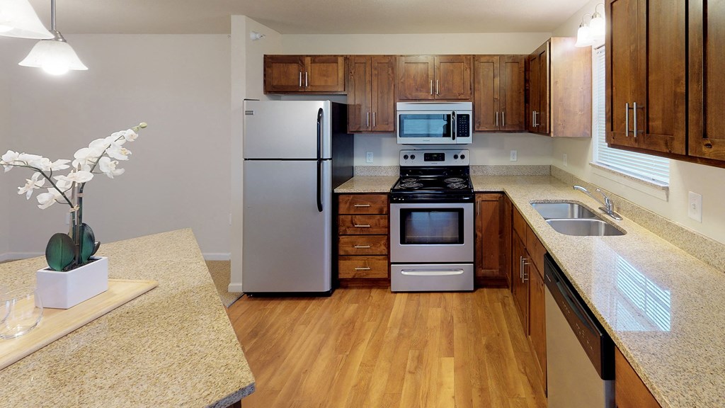 a kitchen with stainless steel appliances and wooden cabinets
