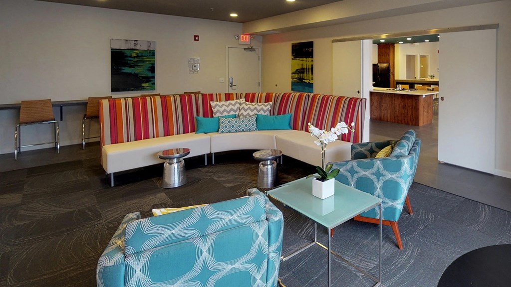 a living room with couches and chairs and a table