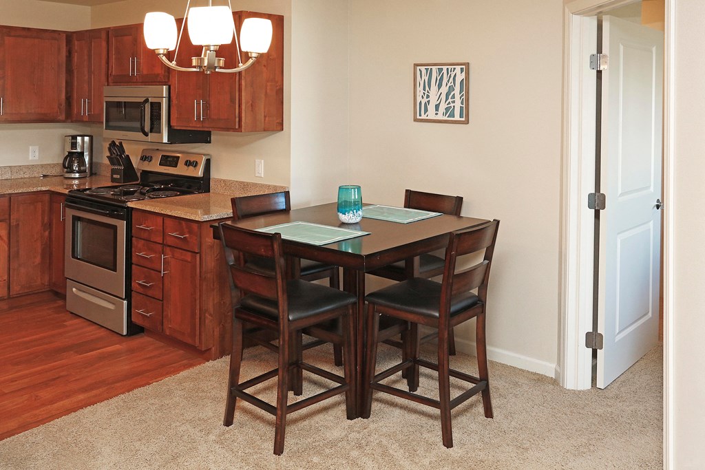 Small Dining Table with Chairs Next to Kitchen