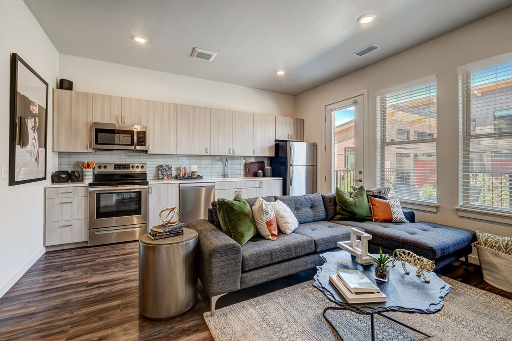 A modern kitchen with a stainless steel appliances and patio or balcony