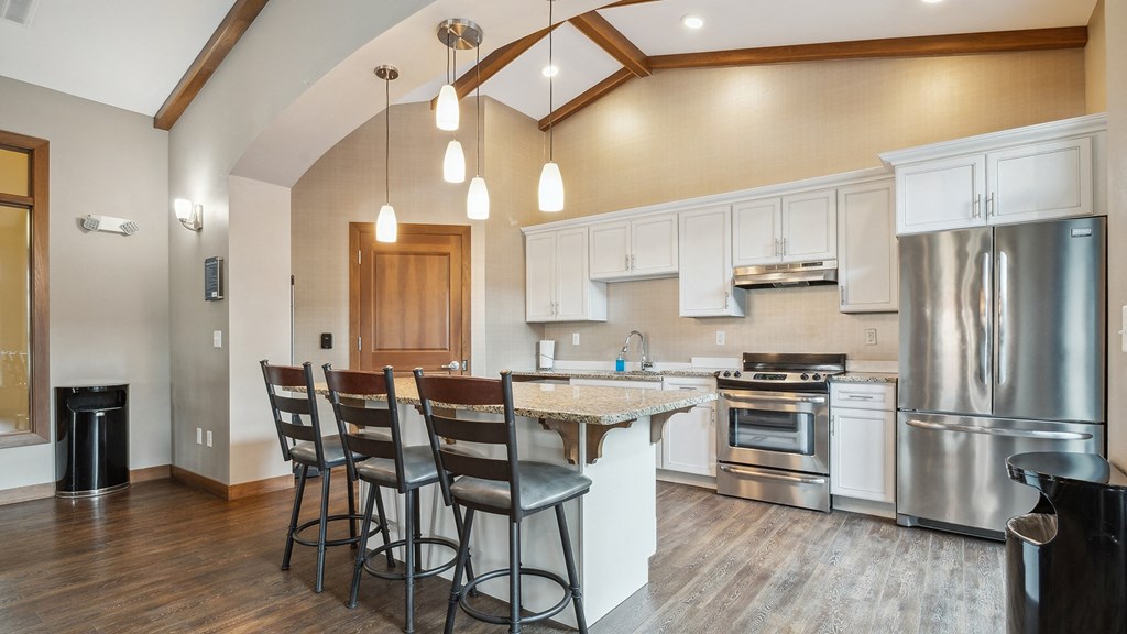 A kitchen with a wooden table and chairs.
