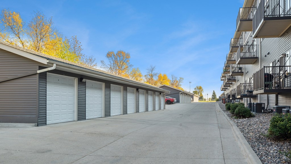 A row of garage doors in a parking lot.