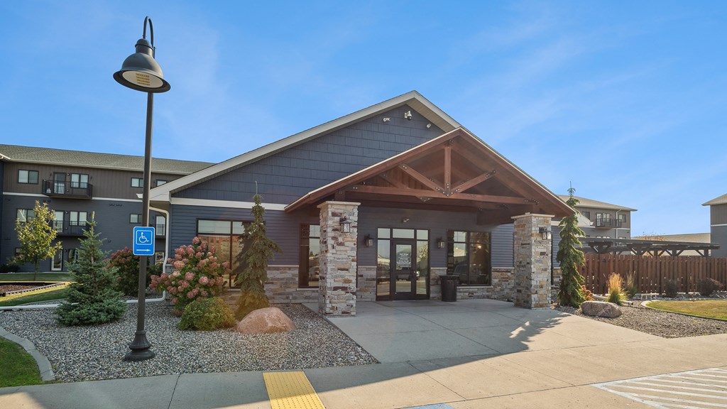 A building with a blue handicap sign in front of it.