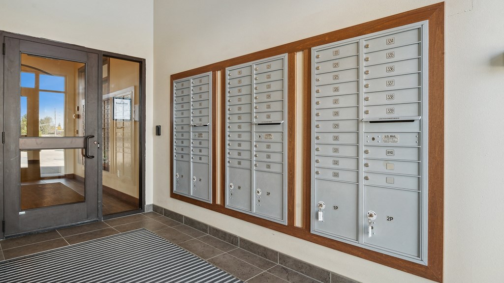 A set of mailboxes are lined up on a wall.