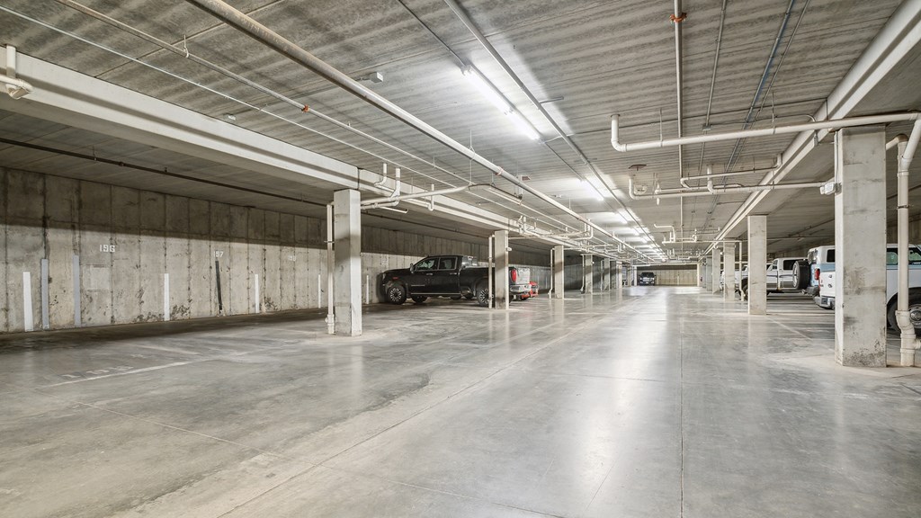 A large, empty parking garage with concrete floors and walls.