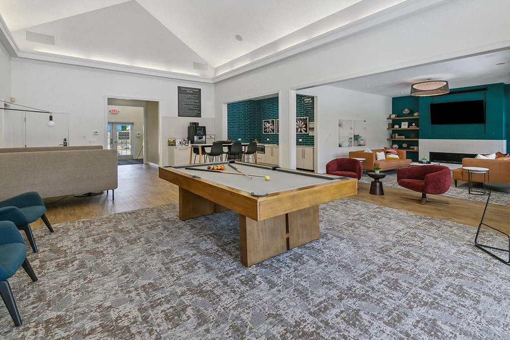 A room with a pool table and a bar at The Donovan Apartment Homes, Lincoln, NE