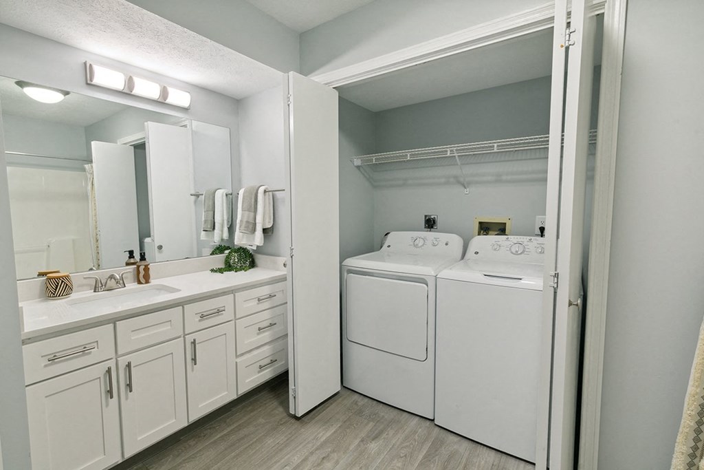 A white laundry room with a washer and dryer at The Donovan Apartment Homes, Nebraska, 68516