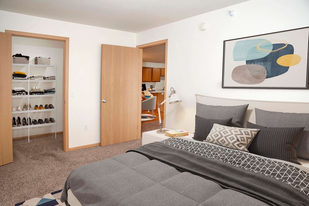 Spacious and bright bedroom with large closets for storage.