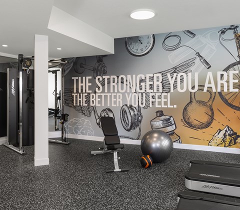 A gym room with a motivational quote on the wall.