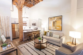 Open living area with high ceilings, wood beams, and an island for entertaining.